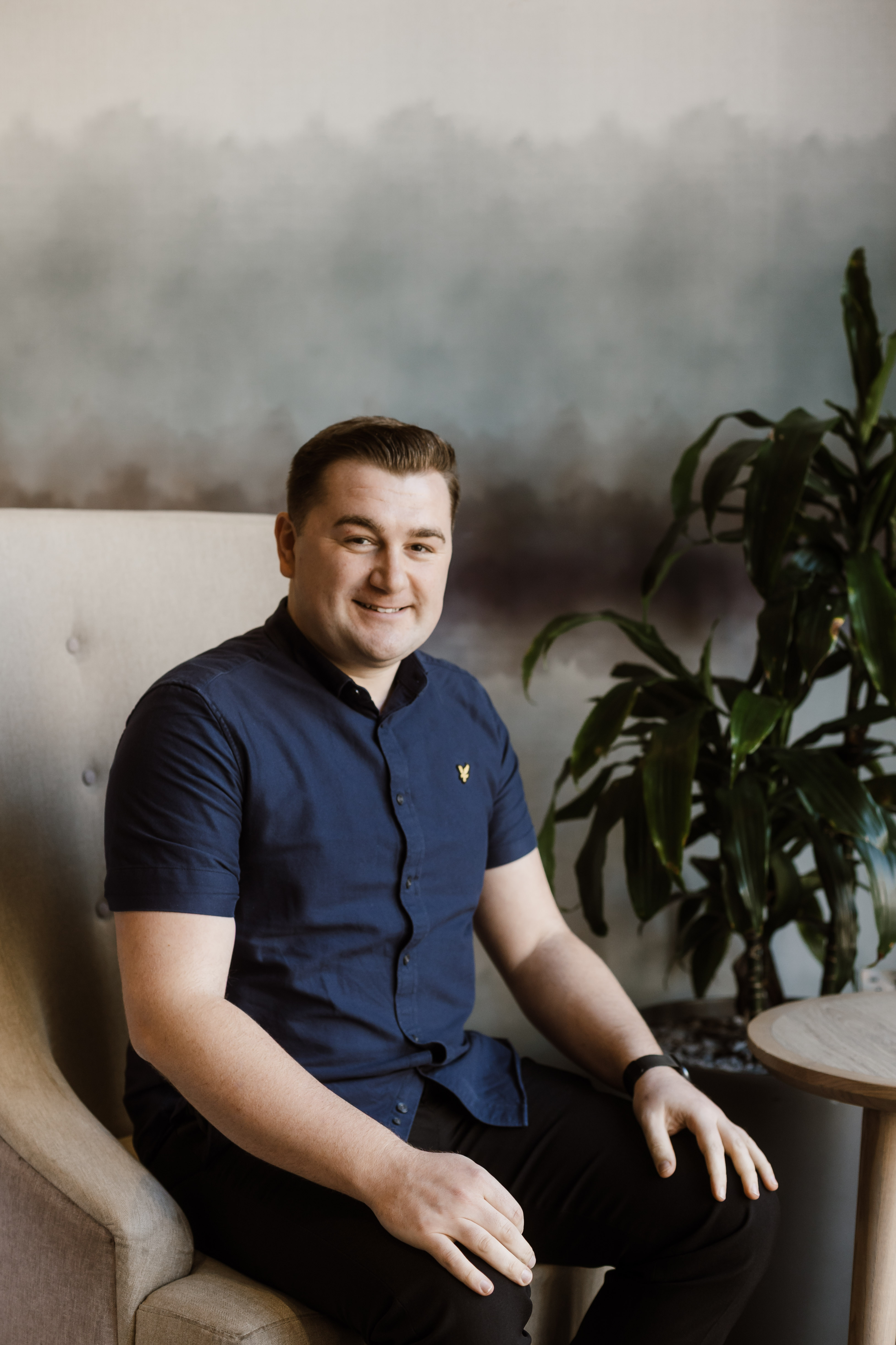 Russell Ash seated in a professional setting